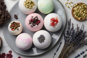Flat lay composition with bath bombs and ingredients on light table