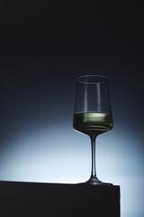 White wine in a transparent glass in low key