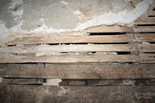 House Renovation Stripped Wall to see Wood Broken Tiles and Bare Walls
