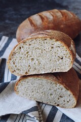 Homemade sourdough bread with seeds on the wooden background