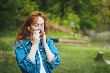 Woman is having flu and she is using nasal spray to help herself. Woman using nasal spray. Nasal spray to help a cold. Sick with a rhinitis woman dripping nose. Woman applies nasal spray - obrazy, fototapety, plakaty