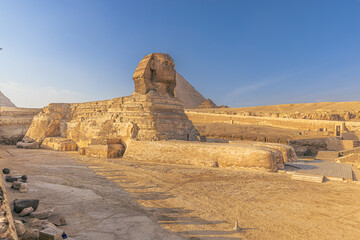 Giza, Egypt -  November 14, 2021: The Great Sphinx by the great ancient Pyramids of Giza, Egypt