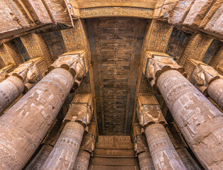 Dendera, Egypt -  November 17, 2021: Majestic columns inside the great ancient Egyptian temple of Dendera at Dendera, Egypt