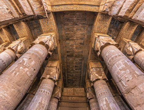 Dendera, Egypt -  November 17, 2021: Majestic columns inside the great ancient Egyptian temple of Dendera at Dendera, Egypt