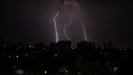 Lightning storm over the city of Maputo at night. Mozambique, November 2021