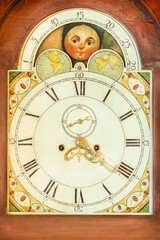 Authentic ancient clock with moon and star rotation in a wooden casing