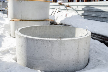 A two-meter reinforced concrete ring of a well, a warehouse of a precast concrete plant.