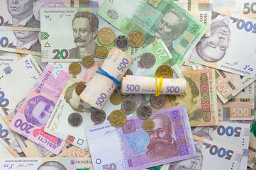background with Ukrainian paper notes and metal money