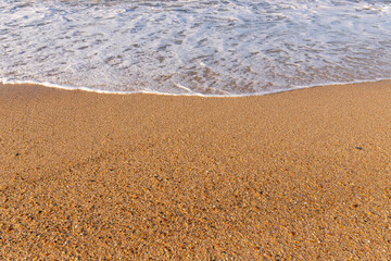 Fototapeta na wymiar Wave on yellow sand. Caspian Sea.