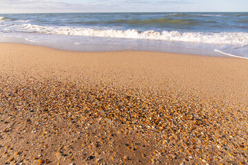 Wave on yellow sand. Caspian Sea.