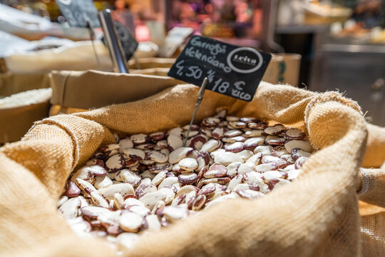 Valencian garrofon in a sack at a vegetable stall in the market. Close up shot.