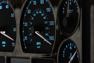 speedometer in car dashboard at full speed in illuminated night mode