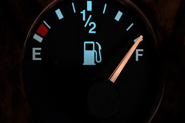 fuel gauge in car dashboard in illuminated night mode  - full - obrazy, fototapety, plakaty