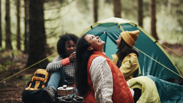 Laughing friends camping in the woods - Powered by Adobe