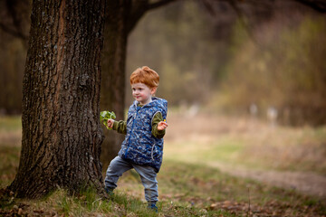 Ukrainian boy walks in the park in the spring with a bouquet of flowers. Copy space