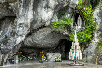 Statue of Virgin Mary in the grotto of Our Lady of Lourdes, France - French famous catholic...