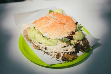 Traditional cemita from Puebla, a dish made up of bread with sesame seeds, cheese, avocado, onion and chicken or pork milanese.