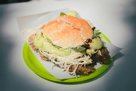 Traditional cemita from Puebla, a dish made up of bread with sesame seeds, cheese, avocado, onion and chicken or pork milanese.