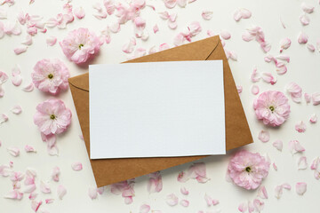 postcard mockup. frame of pink sakura flowers and white blank for text. wedding card. invitation © Palanga