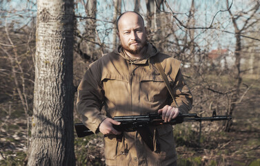 warrior with a machine gun in his hands is on the defensive