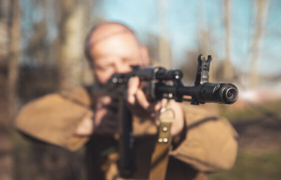 muzzle of a machine gun close-up in the hands of a man