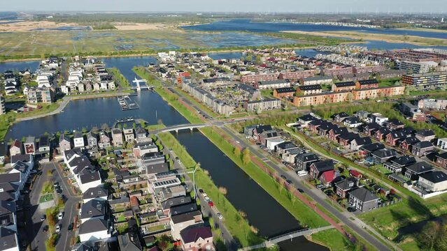 Modern green neighbourhood in Almere, The Netherlands, surrounded by water and nature, city built on reclaimed land (Flevoland polder). Aerial view. 