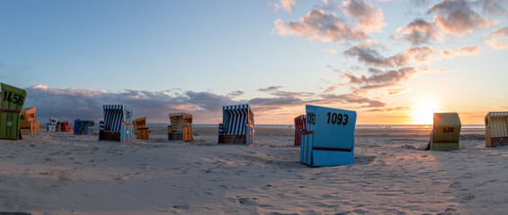 Beautiful view of a beach with cabins in Langeoog, Northern Germany - obrazy, fototapety, plakaty