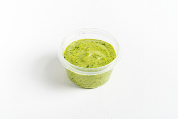 green sauce dip on white