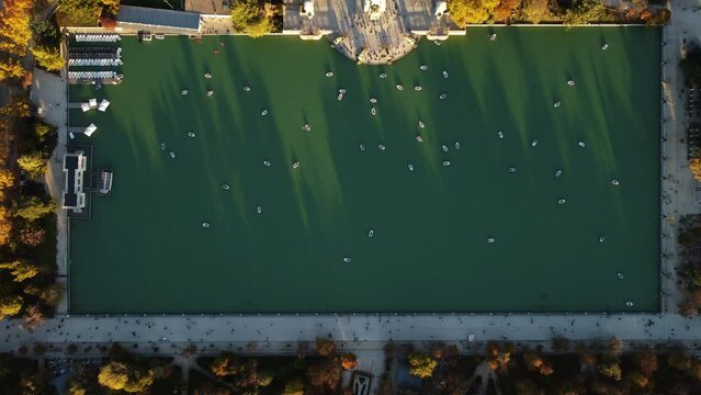 Static drone footage of the Great Pond of the Retiro Park with small boats