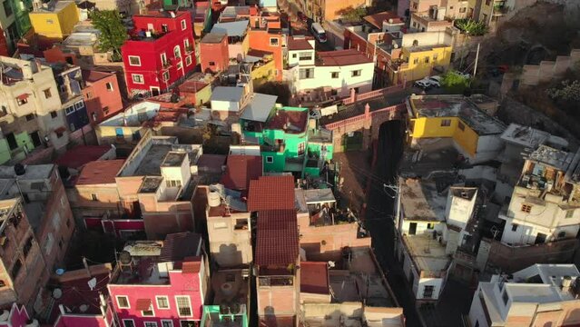 Aerial Approach Vibrant Colorful Latin American Hill Village of Guanajuato Mexico at Foot of Mountain. 