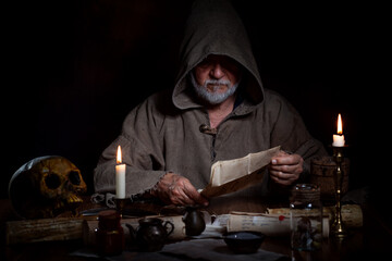 Old medieval man studies occultism