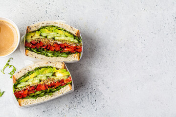 Vegetable sandwich in paper wrap. Vegan healthy food, takeaway food.