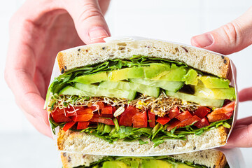 Vegetable sandwich in paper wrap. Vegan healthy food, takeaway food.