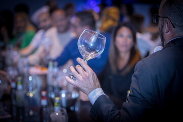 Cocktail series: people celebrating at a table with their glasses, enjoying cocktails in the atmosphere of a cruise party. Ice cubes, citrus peel.
