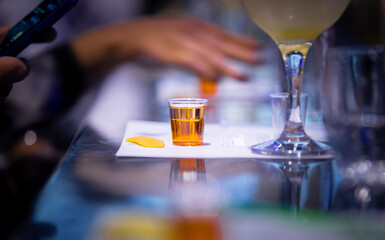 Cocktail series: people celebrating at a table with their glasses, enjoying cocktails in the atmosphere of a cruise party. Ice cubes, citrus peel.