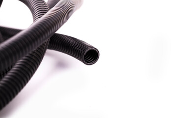 on a white background. black corrugated tube for laying cable in the car