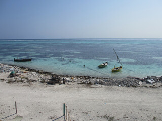 Fototapeta na wymiar Maldives. Indian Ocean. Fishing island. White sand, blue water. Old boats in the ocean.