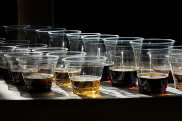 beer in plastic cups in a counter light