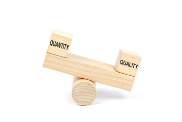 Wooden blocks designed as a seesaw with Quality outweighs the Quantity, Business Quality Vs...