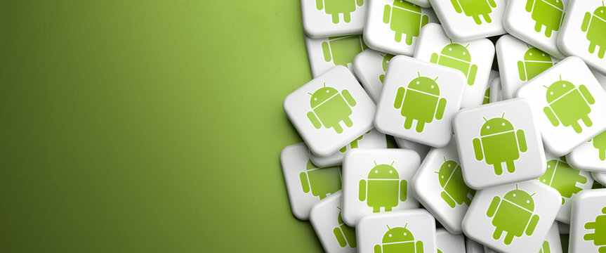 Logos of the smartphone operating system Android on a heap on a table. Copy space. Web banner format.