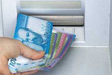Woman Takes Chilean Money From ATM, An Economic Concept Of Inflation And Rising Cost Of Living