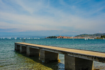 The historic town of Izola on the Adriatic coast of Slovenia. A sailing school practices on the...