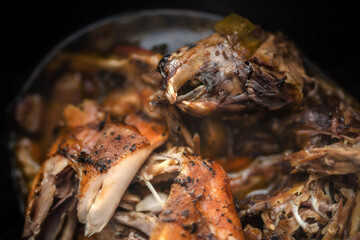 A close-up view of the slow-cooked broth from a whole rabbit.