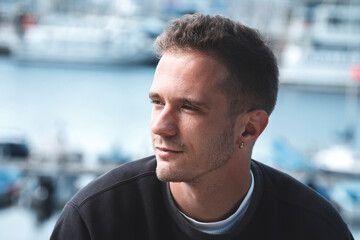 portrait of young tourist man with marina background