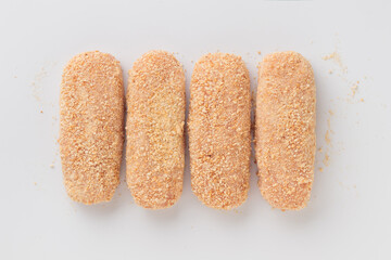 Raw beached meat cutlets isolated on a white background