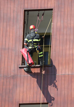 Climber Firefighter Go In The House By Window