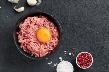 Cutlet ingredients beef farce meat with egg in a plate