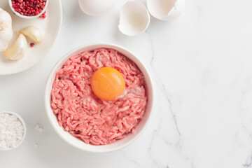 Cutlet ingredients beef farce meat with egg in a plate