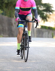 Naklejka na ściany i meble Cyclist with sportswear on a racing bike pedaling