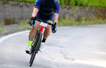Fototapeta na wymiar Cyclist on a racing bike engaged in the dangerous curve